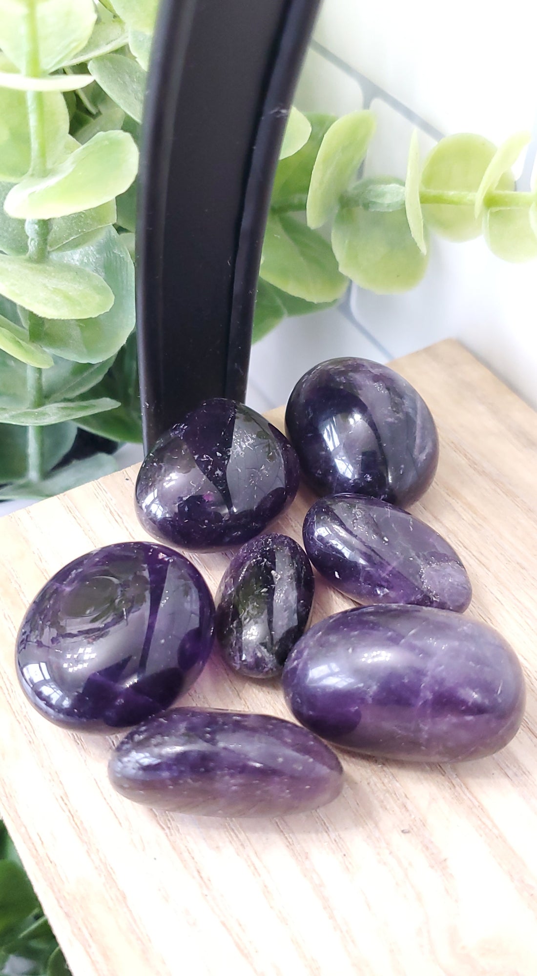 Dark Amethyst piled up on a wooden shelf