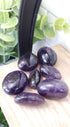 Dark Amethyst piled up on a wooden shelf