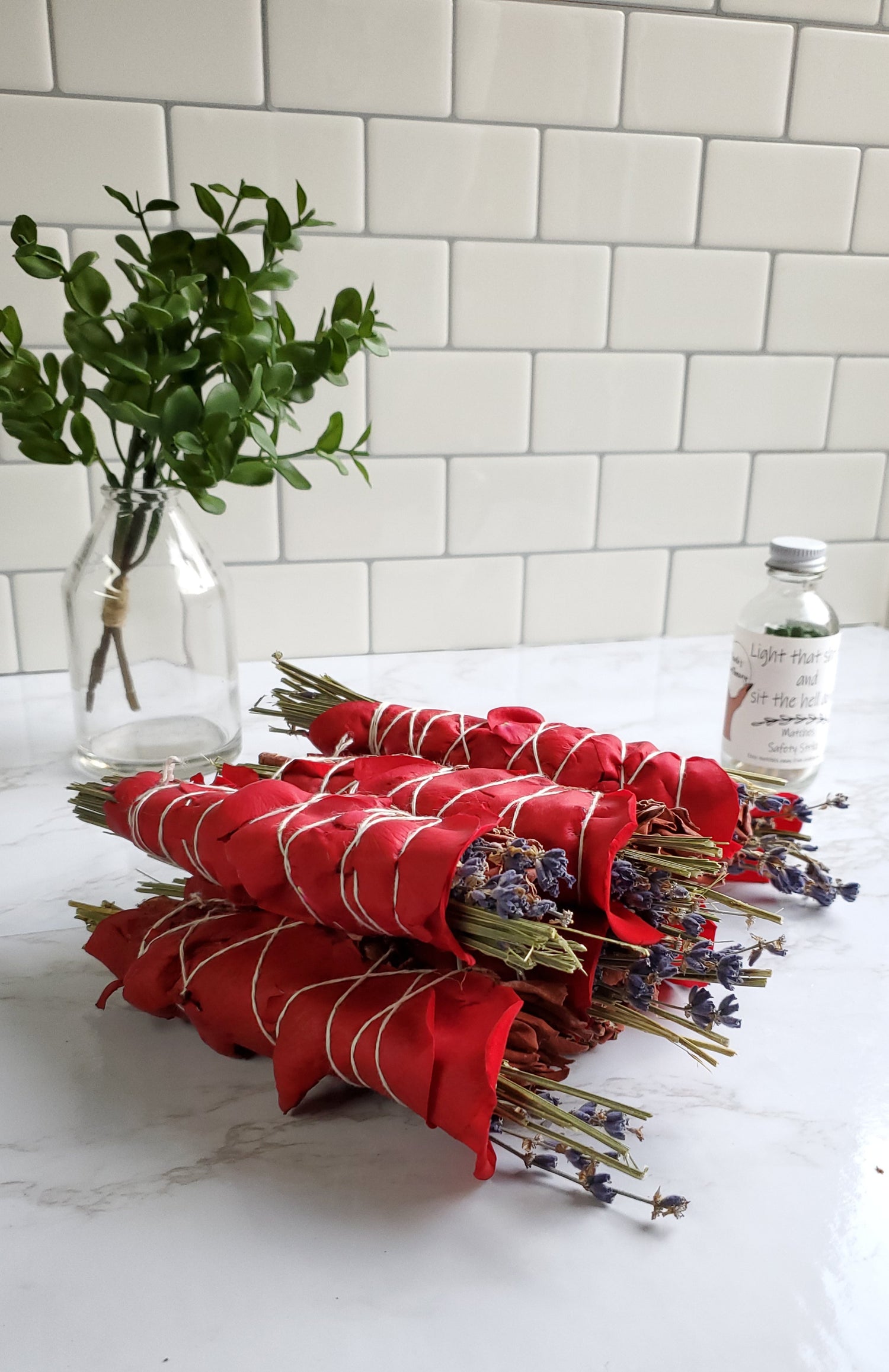 Dragons Blood Sage Stick piled up on a white table