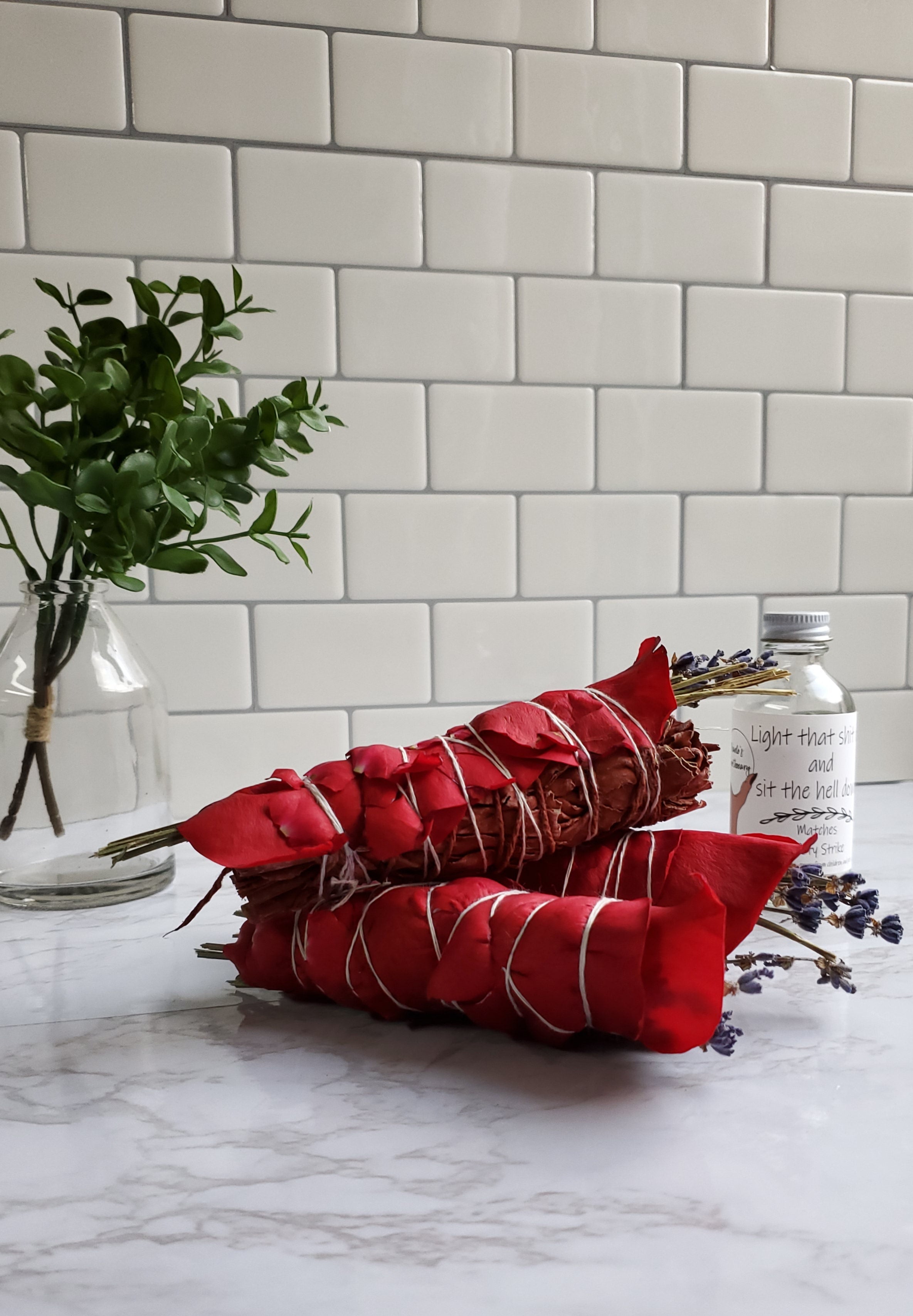 Dragons Blood Sage Stick piled up on a white table