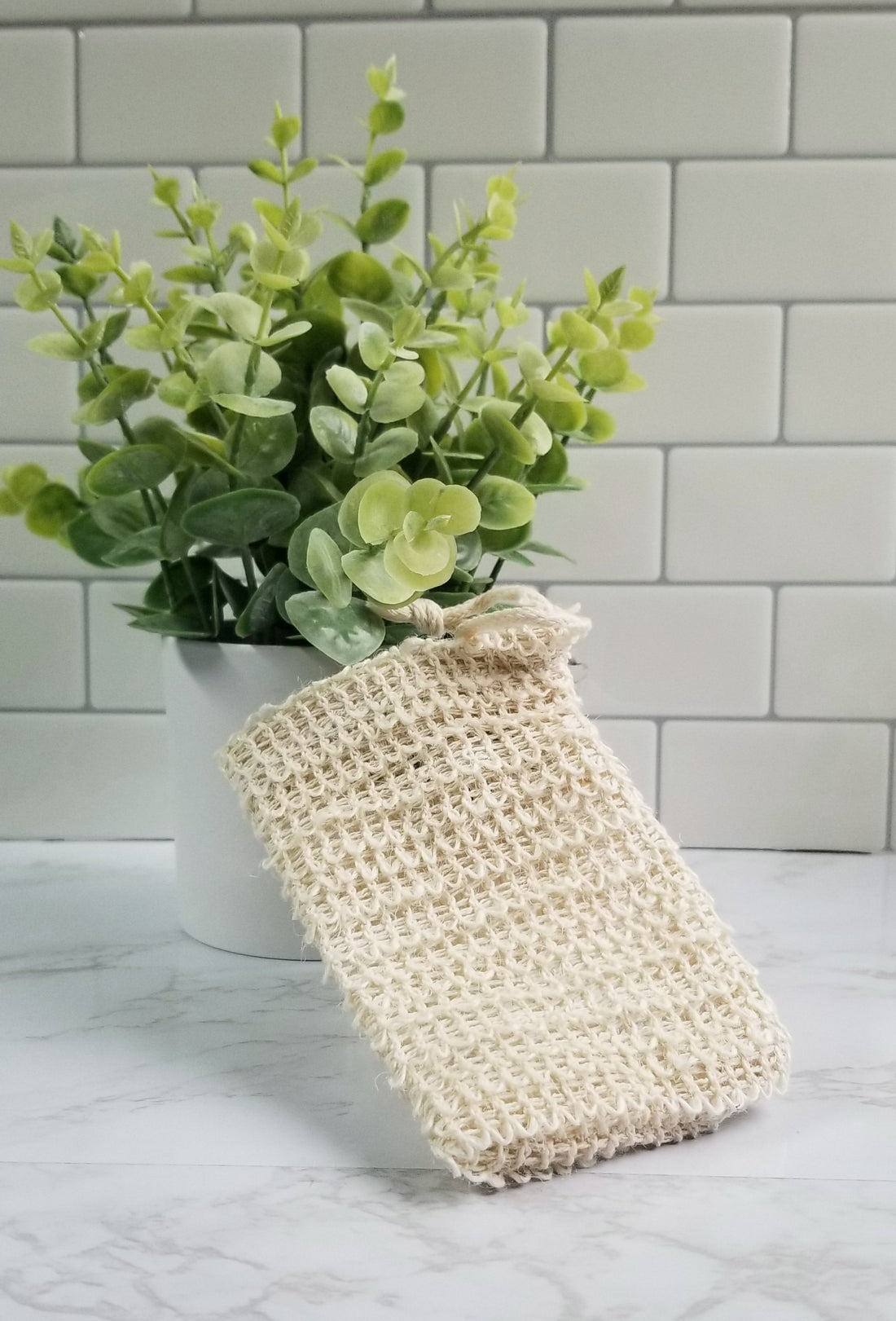 Exfoliating Soap Bag propped up on table