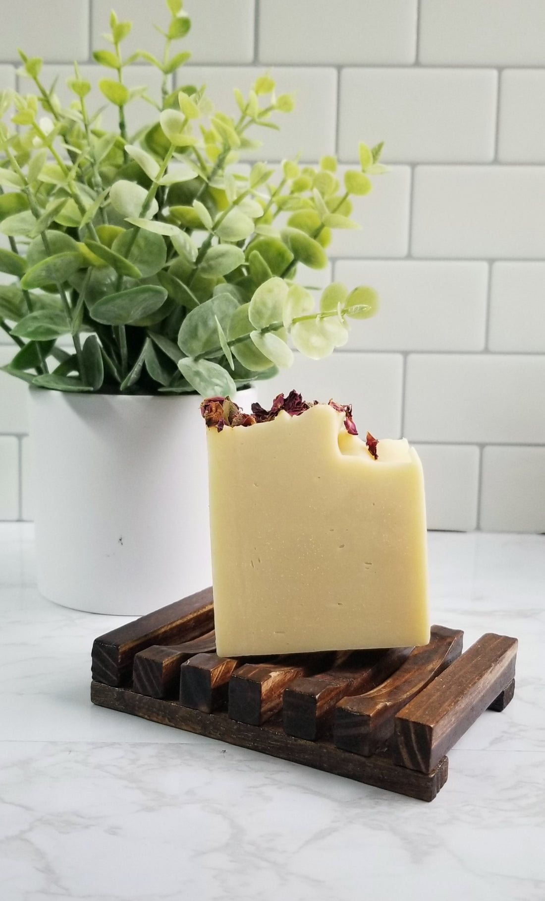 feeling myself soap with roses on top on top of wooden soap dish