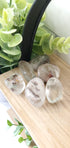 Garden Quartz in a pile on a wooden shelf