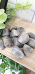 Labradorite crystals stones piled up on wooden shelf