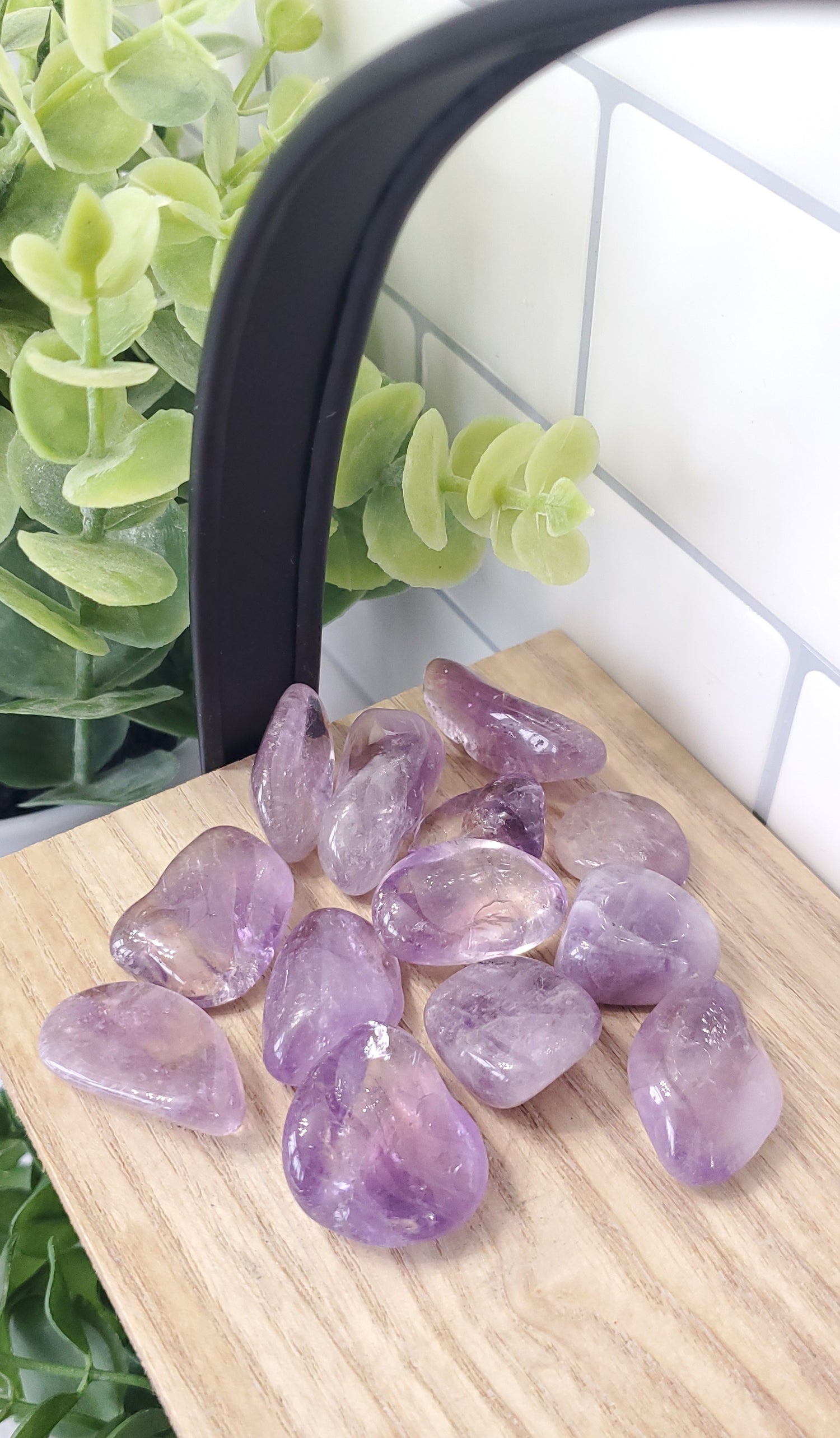 Light Amethyst crystals stones piled on wooden shelf