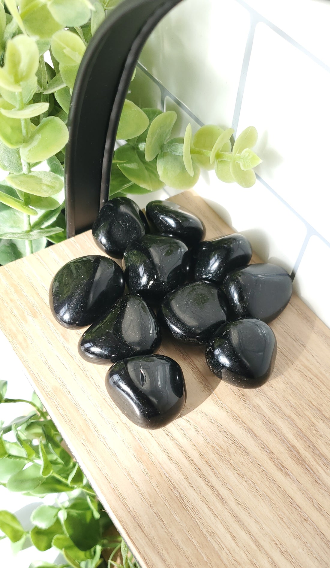 Obsidian crystals stones piled up on shelf