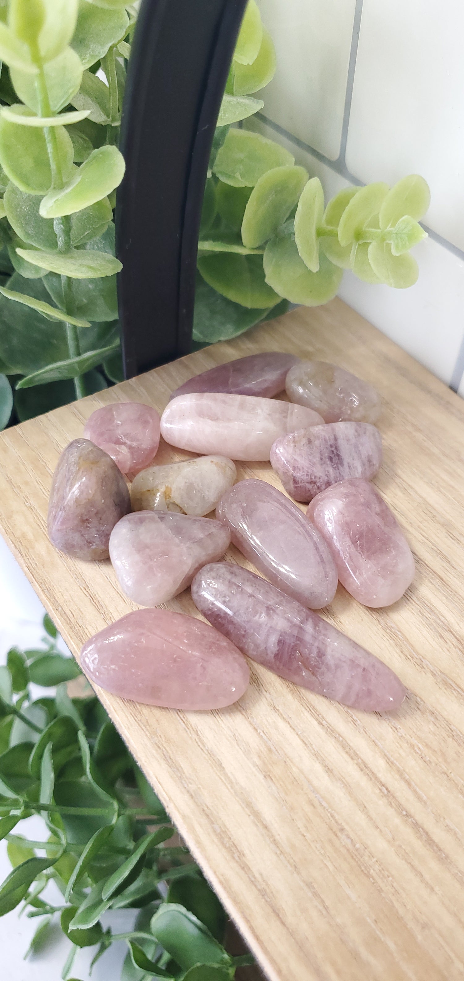 Pink Amethyst crystals stones piled on wooden shelf