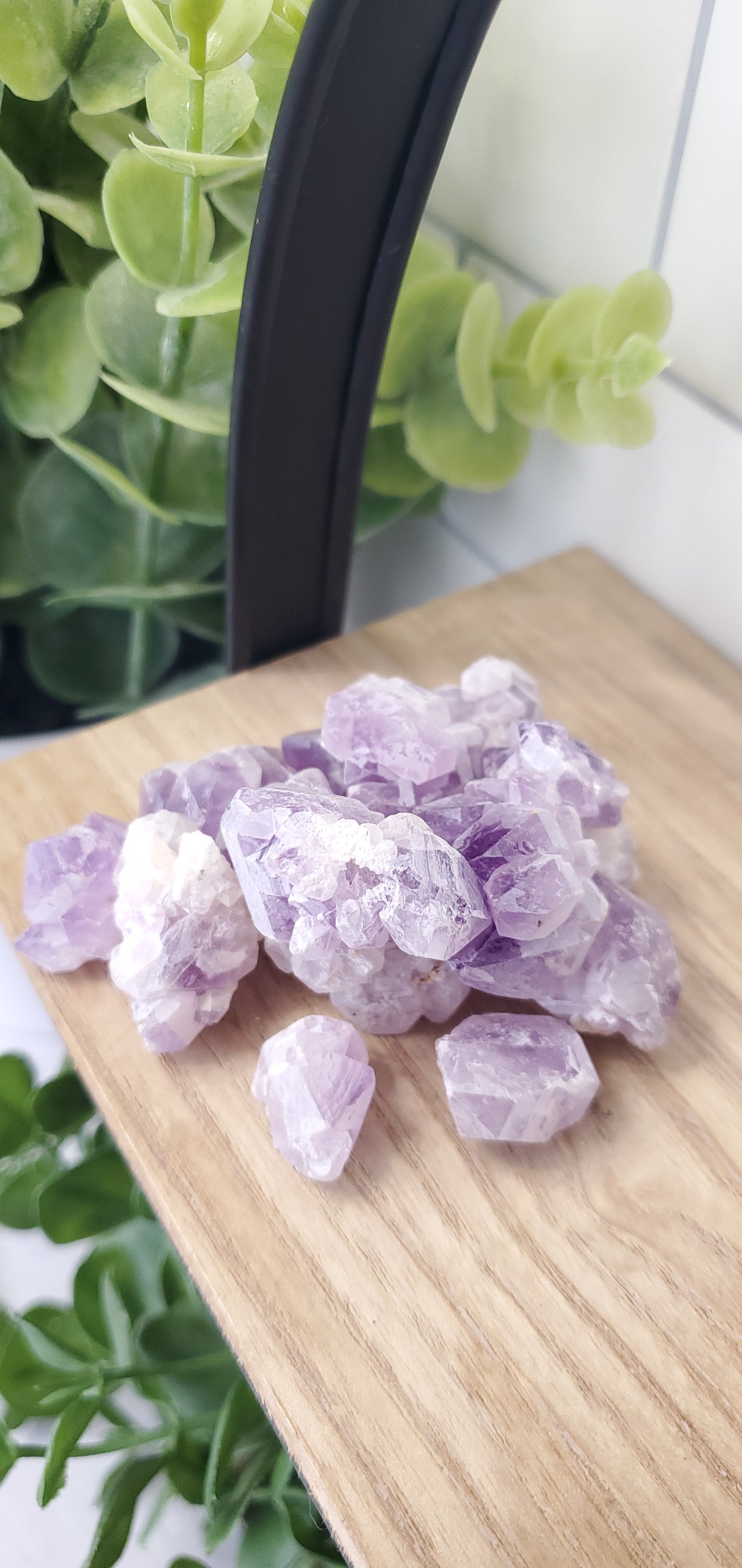 Raw Amethyst crystals stones piled up on shelf