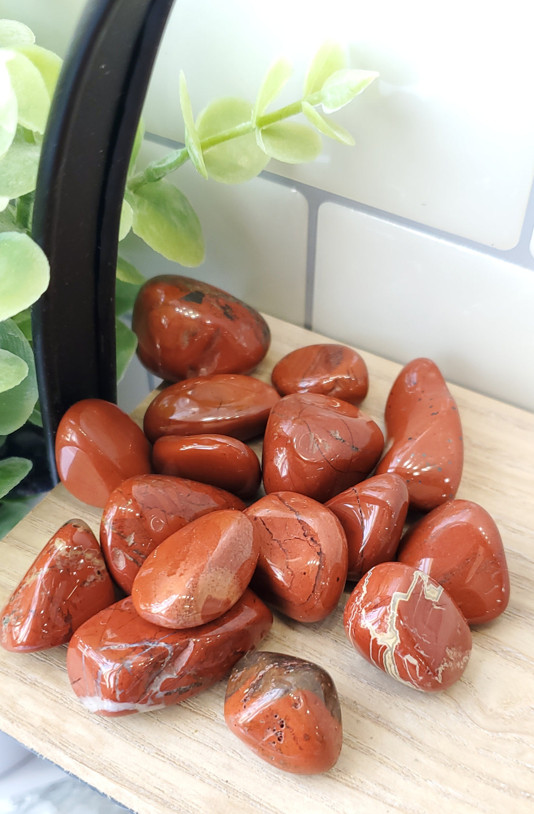 Red Jasper crystals stones piled up on wooden shelf