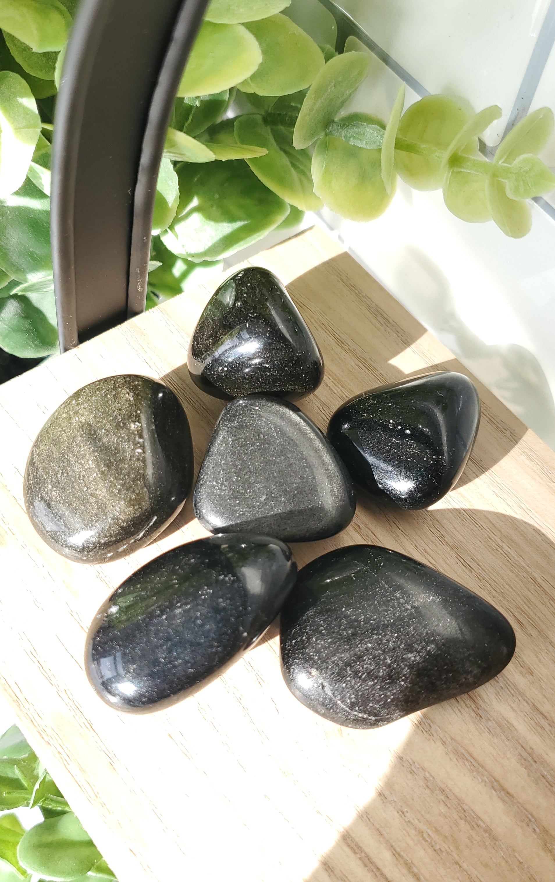 Silver Sheen Obsidian piled on a shelf